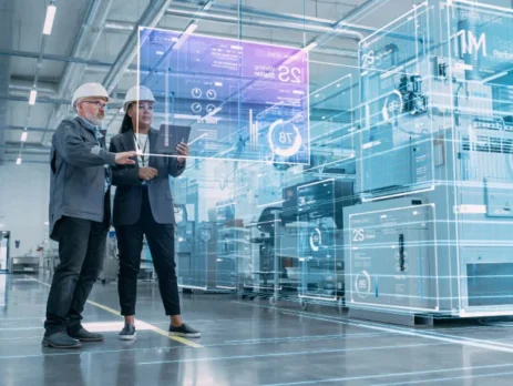 a man and woman wearing hardhats looking at a large transparent screen