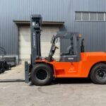 "Machinex FD100 Diesel Forklift parked outdoors, showcasing its robust design and advanced features for heavy-duty industrial lifting tasks.