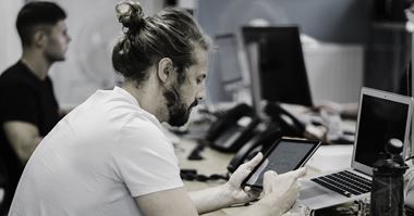 a man looking at a tablet